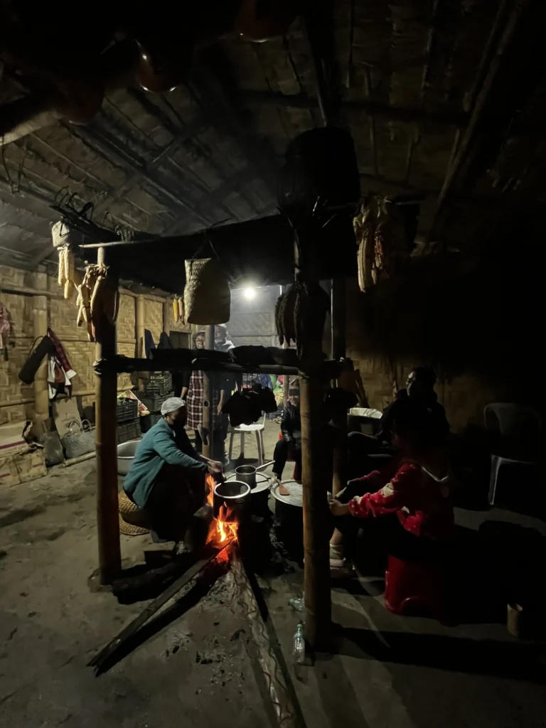 Cooking over fire inside a morung at Hornbill Festival