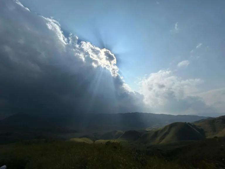 Sun rays breaking through clouds at Dzukou Valley