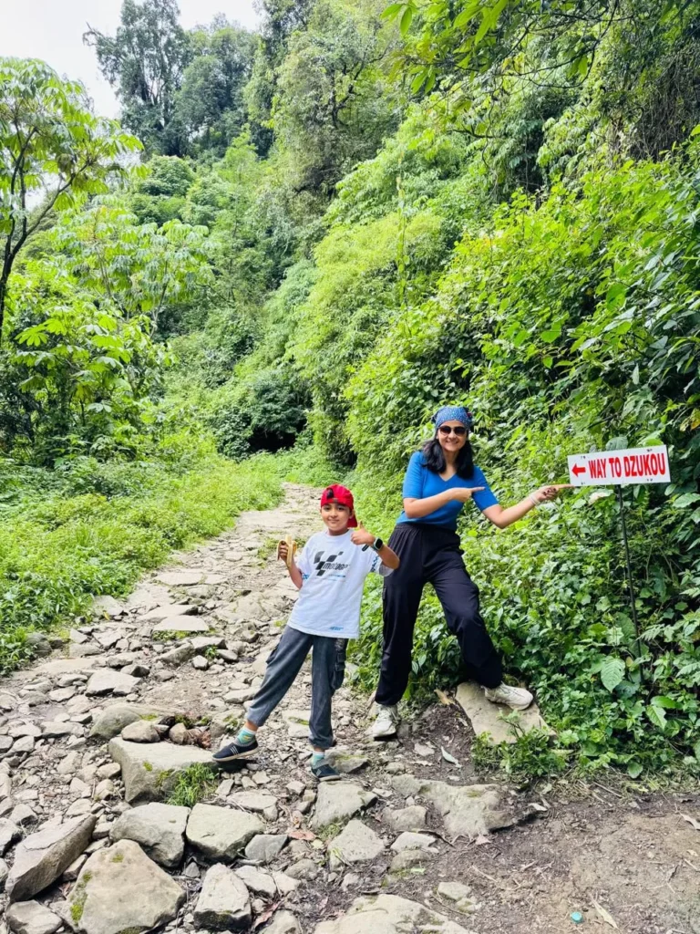 Woman and child at Dzukou Valley trail sign